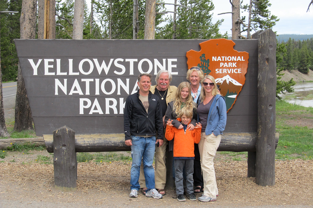 Small Group Yellowstone Tour in Front of Park Sign - Buffalo Roam Tours