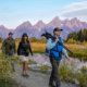 Visitors entering Yellowstone National Park with updated 2026 national park entrance fees signage at the park entrance.