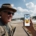 Yellowstone tour guide reacting to travel app near geothermal boardwalk in Yellowstone National Park during guided wildlife tour comparison blog